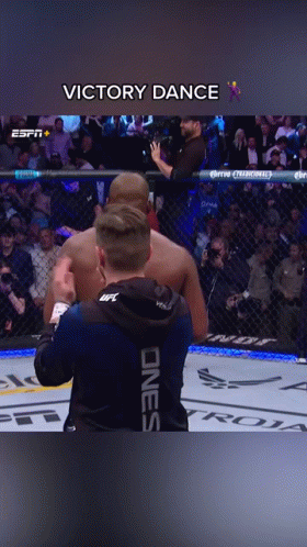 Man in UFC Hoodie Next to Cage