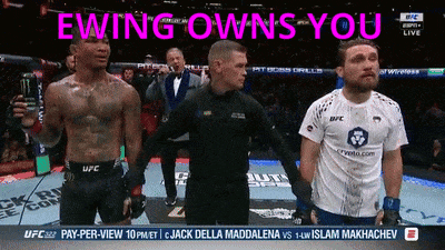 Man in UFC Shirt Standing Before Referee