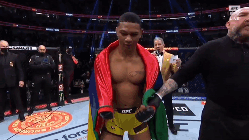Man In UFC Shorts Standing On Stage GIF