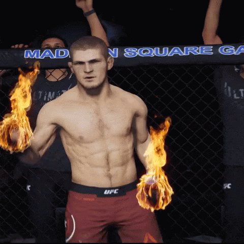 Man In UFC Shorts With Flames In Hands GIF