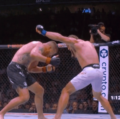 Man In UFC Uniform Helping Another Man GIF