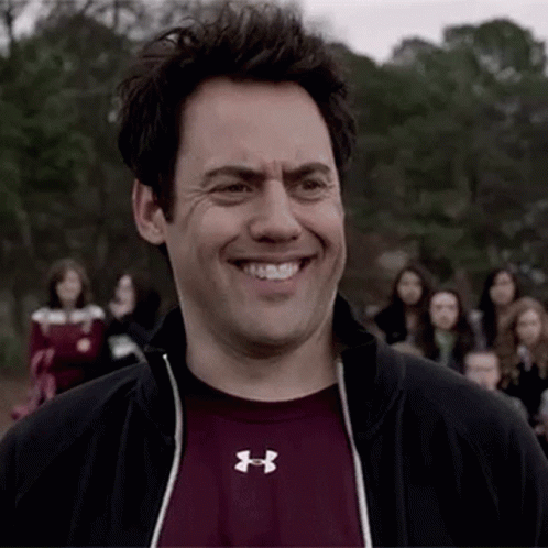 Man in Under Armour Shirt Smiling in Crowd