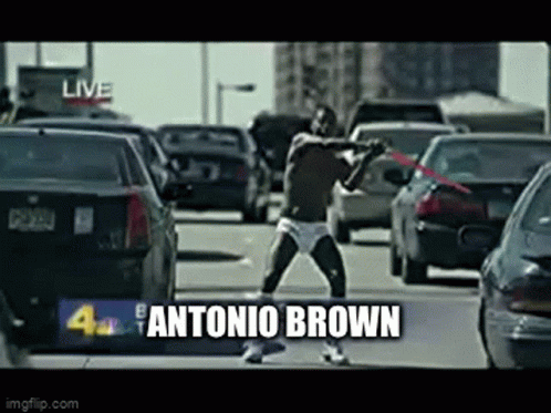 Man in Underwear Holding Red Sword on Busy Street