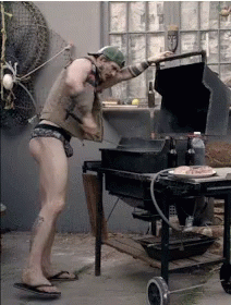 Man in Underwear Standing by Grill