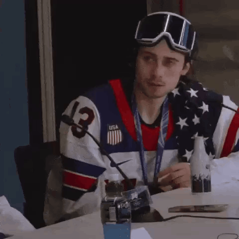 Man in USA Jersey and Goggles at Table