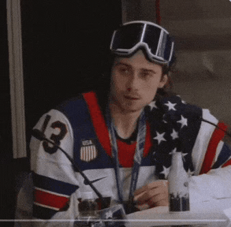 Man in USA Jersey and Goggles Sitting
