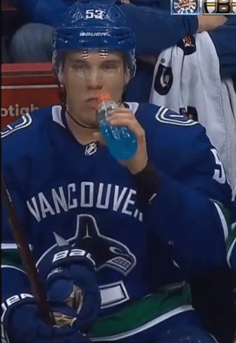 Man in Vancouver Jersey Drinking Blue Bottle