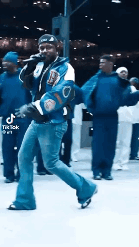 Man in Varsity Jacket Singing and Dancing