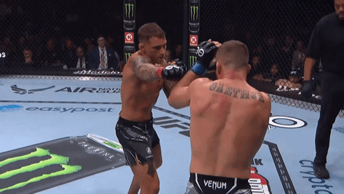 Man in Venum Belt Fighting Another Man in Ring