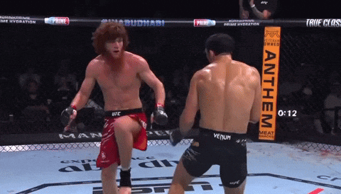 Man in Venum Shorts Kicks Another Man in Ring