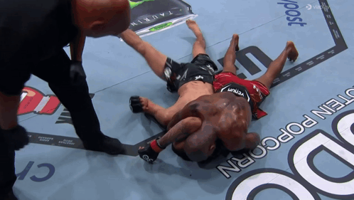 Man In Venum Shorts Laying On Ground GIF