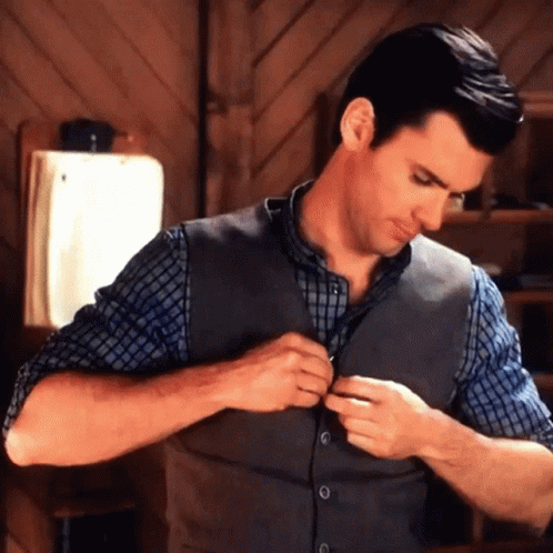 Man in Vest and Plaid Shirt Adjusting Vest