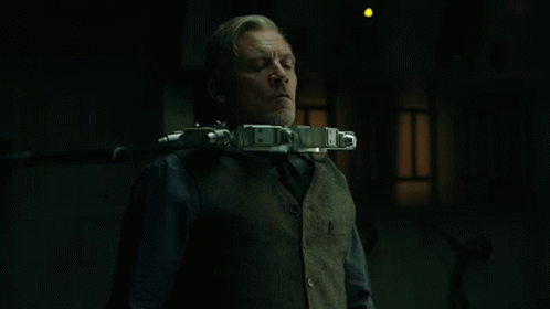 Man In Vest And Tie With Gun Neck Device GIF