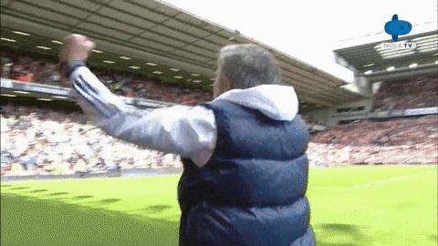Man in Vest Arms Outstretched on Soccer Field