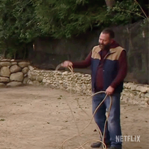 Man in Vest Holding Rope with Netflix Logo