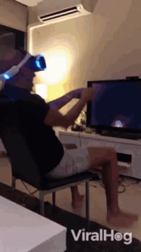 Man in VR Headset in Front of TV
