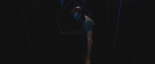 Man In VR Headset Walking Through Dark Tunnel GIF