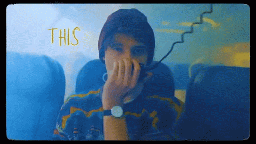 Man in Watch and Beanie Covering Face Saying This
