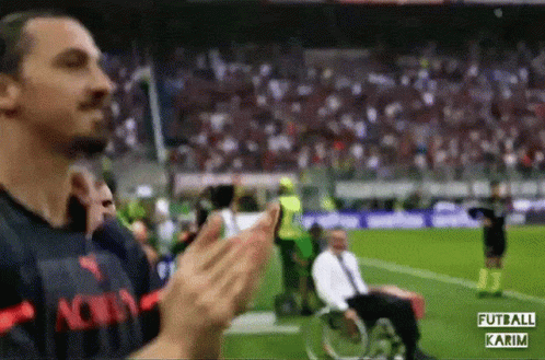 Man in Wheelchair Applauding Soccer Player