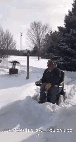 Man in Wheelchair Driving Snowy Driveway