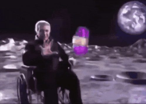 Man in Wheelchair on Moon Holding Purple Object