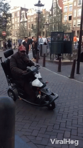 Man In Wheelchair Riding Mobility Scooter With Viralhog GIF