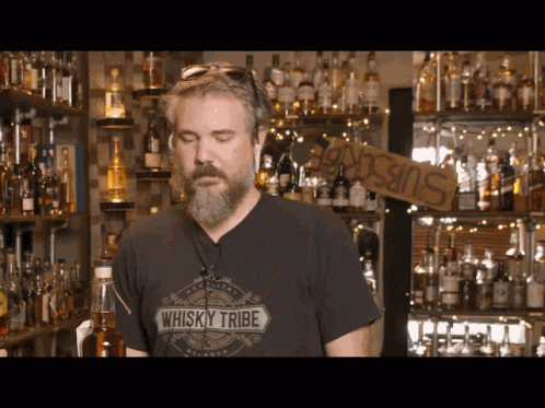 Man in Whisky Tribe Shirt at Bar
