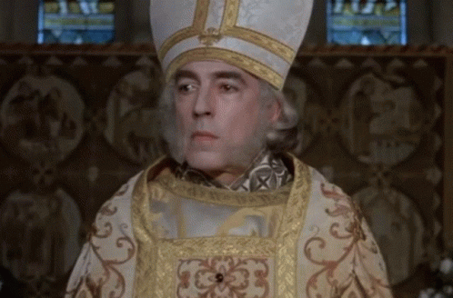 Man In White And Gold Cross Hat At Stained Glass Window GIF