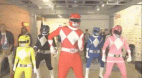 Man in White and Gold Power Ranger Costume With 'Feel the Power' Text