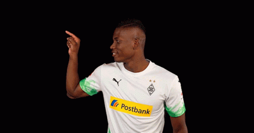 Man in White and Green Postbank Jersey Pointing Up