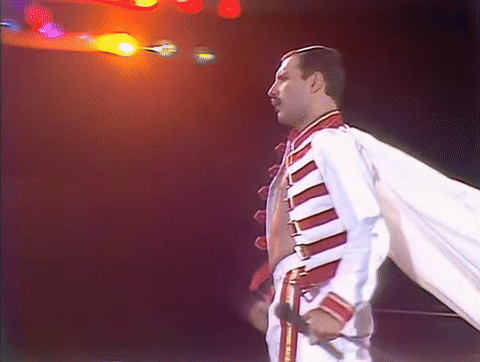 Man in White and Red Jacket Holding Microphone