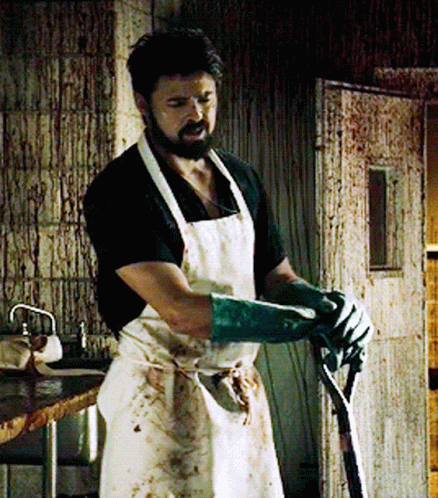 Man in White Apron and Green Gloves