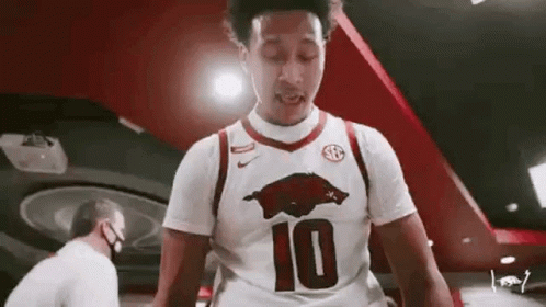 Man in White Basketball Jersey Number 10 in Gym