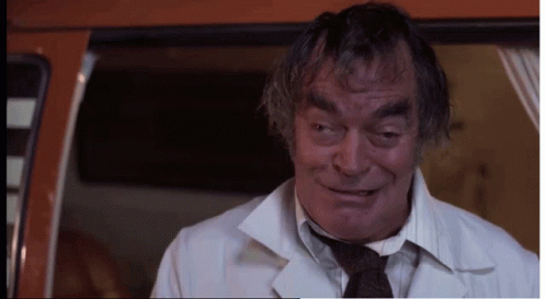 Man in White Coat and Tie Looking at Camera