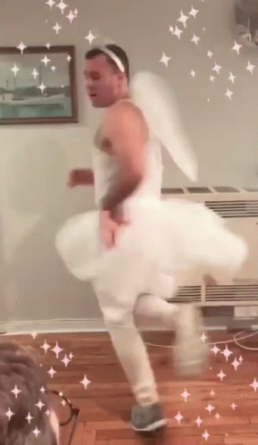 Man In White Dress And Angel Wings Dancing GIF