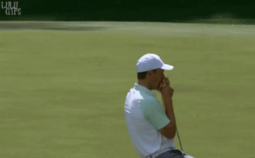 Man in White Hat and Green Shirt Holding Golf Club
