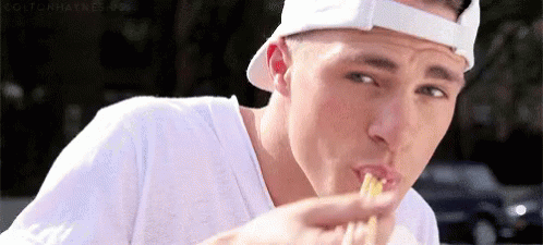 Man in White Hat Eating Sandwich