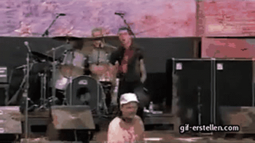 Man In White Hat Standing Before Drum Set GIF