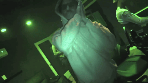 Man in White Hoodie in Dark Room