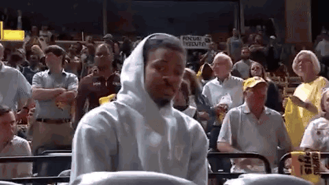 Man in White Hoodie Watching Basketball Game in Crowd