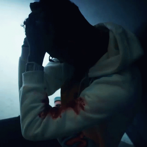 Man in White Hoodie With Blood on Arms