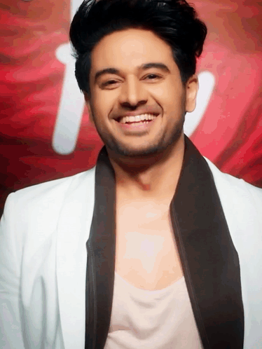 Man in White Jacket and Black Tie Smiling