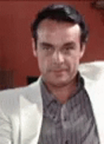 Man in White Jacket and Striped Shirt