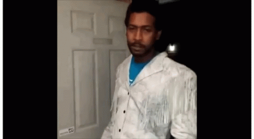 Man in White Jacket at Door