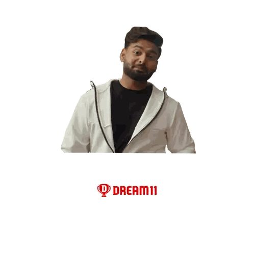 Man in White Jacket in Front of Dream Big Logo