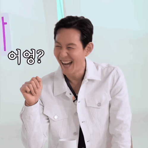 Man in White Jacket Smiling Pointing with Question Mark