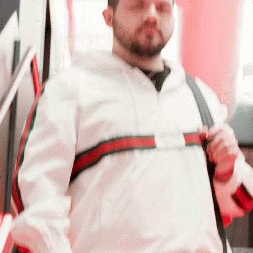Man in White Jacket With Red and Green Striped Sleeves