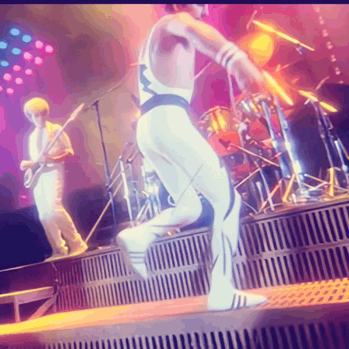 Man in White Jumping on Stage