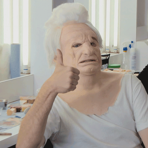 Man in White Mask Giving Thumbs Up