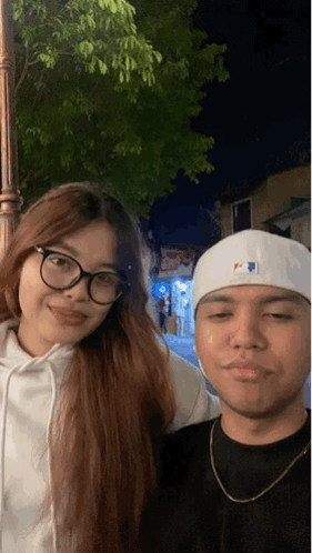 Man in White MLB Hat Posing With Woman